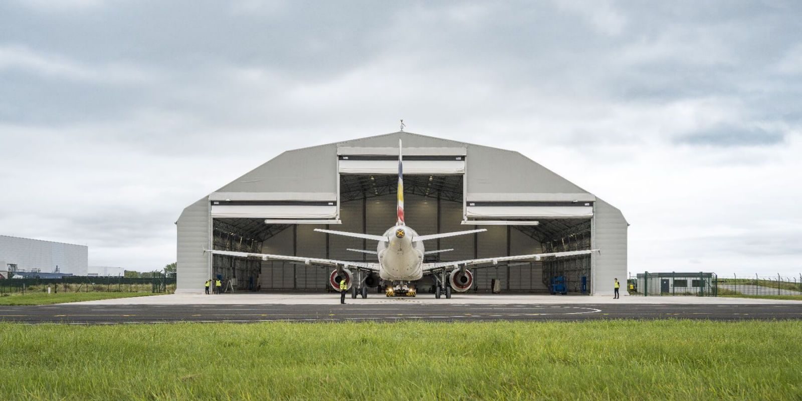 An end-of-life airframe positioned in front of a maintenance hangar